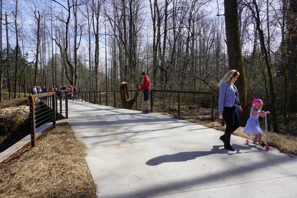 Families and friends enjoying The LINC on foot, bikes, and scooters